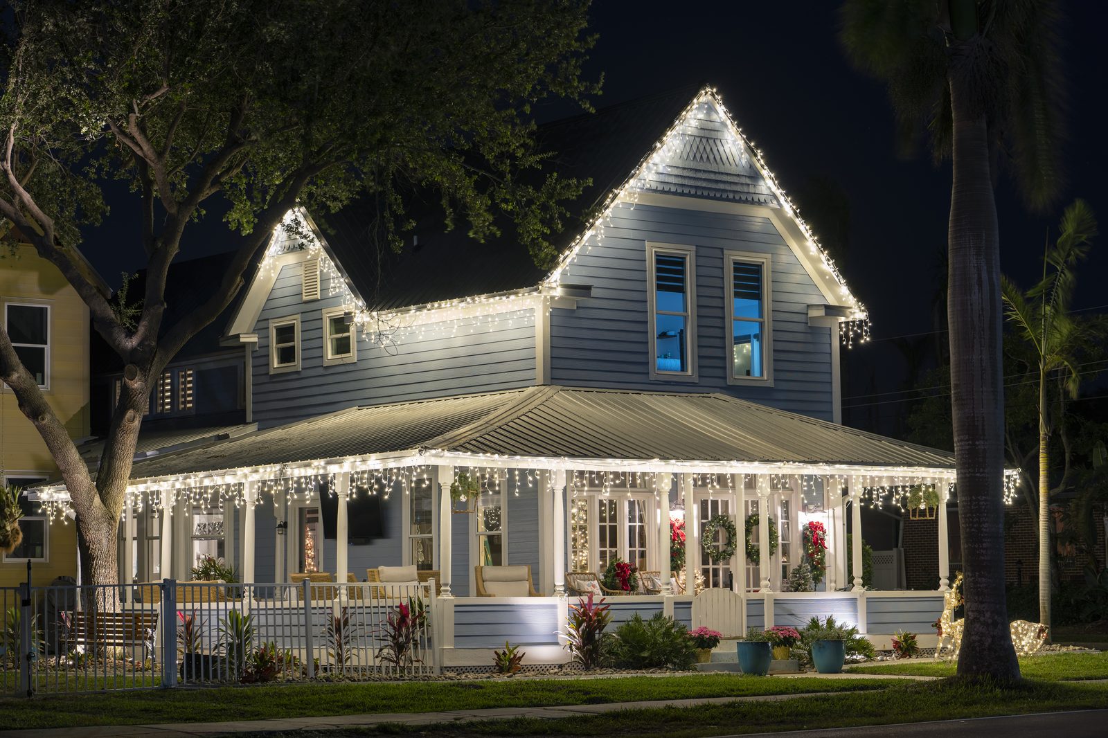 Napa Valley home with warm white Christmas lights along the full roofline at dusk